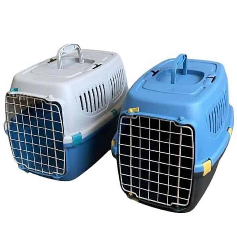 Two grey plastic cat carriers placed side by side, each featuring a front metal door with secure latches and ventilation slats along the sides.